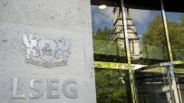 LSEG building entrance with company logo and reflections of a church tower and trees in the glass facade
