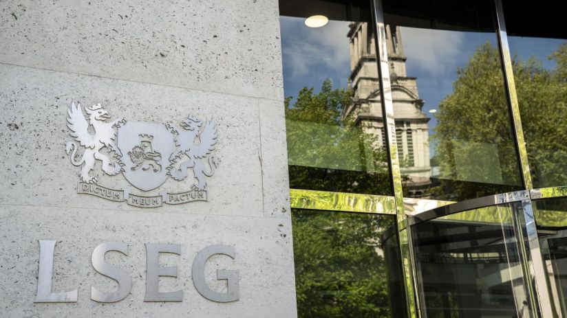 LSEG building entrance with company logo and reflections of a church tower and trees in the glass facade