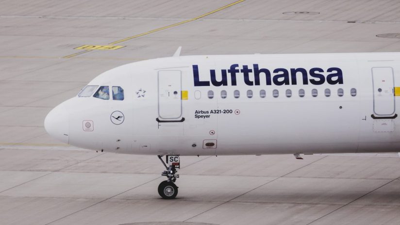 Lufthansa aircraft on tarmac with logo visible, showcasing airlines fleet under clear sky in a business news context
