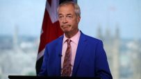 Nigel Farage delivering a speech in July 2026, wearing a suit, addressing an audience at a political event.