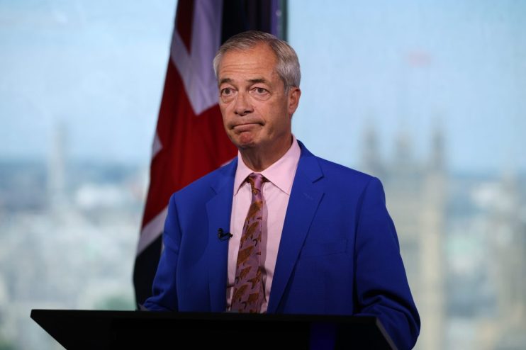 Nigel Farage delivering a speech in July 2026, wearing a suit, addressing an audience at a political event.