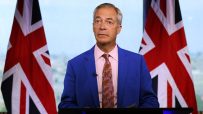 Nigel Farage speaking at a podium during a press conference, addressing current political issues and public concerns