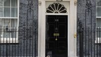 Number 10 Downing Street entrance with iconic black door, symbolizing British political power and leadership