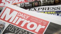 Stack of newspapers including Daily Mirror, Daily Express, and Daily Star, showcasing headlines and mastheads.