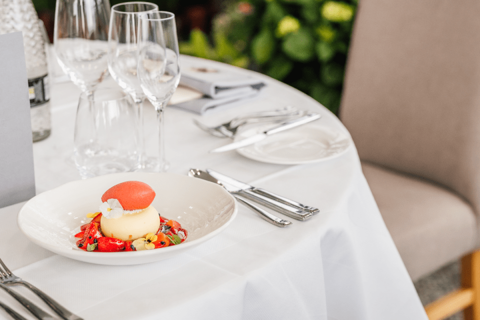 Simon Rogan, Michelin-starred chef, showcasing a gourmet dish at Ascot, highlighting culinary excellence and innovation.