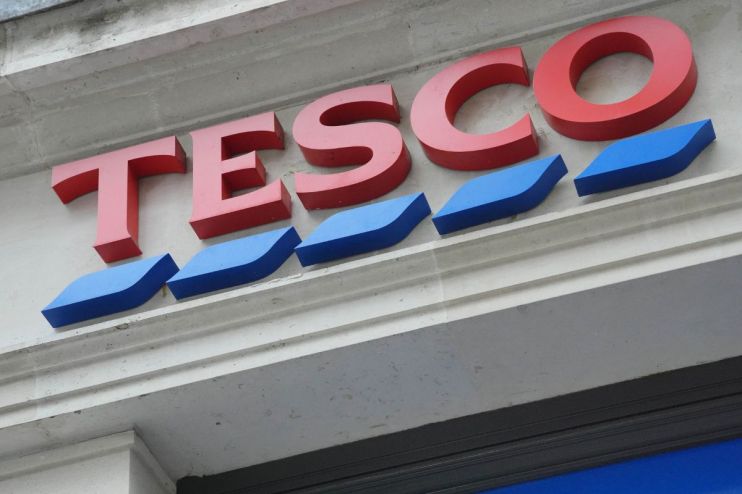 Tesco storefront with shoppers entering and exiting, highlighting the brands popularity and bustling retail environment