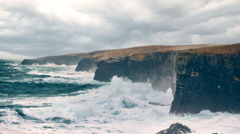 Scenic view of the Cliffs of Caithness, highlighting the rugged coastline near Old Pulteney distillery in Scotland.