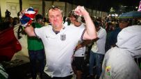 World Cup celebration with cheering fans, colorful flags, and jubilant players on the field during a thrilling match