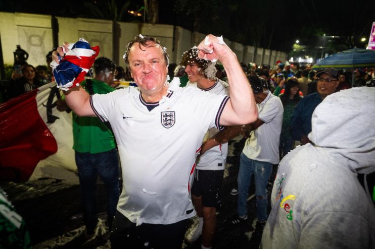 World Cup celebration with cheering fans, colorful flags, and jubilant players on the field during a thrilling match