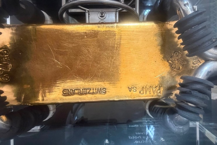 Gold bar stamped PAMP SA SWITZERLAND on display at the Bank of England Museum, showcasing financial assets.