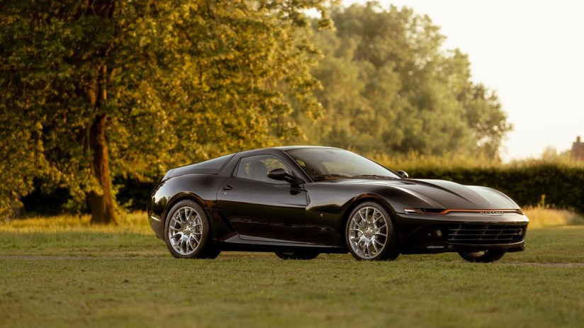 Ferrari Daytona Hommage sports car in vibrant red, showcasing sleek design and iconic style, parked on a scenic road.