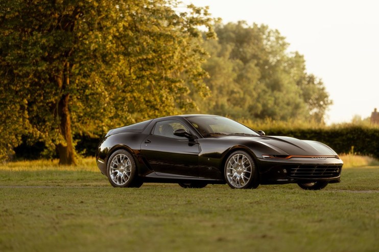 Ferrari Daytona Hommage sports car in vibrant red, showcasing sleek design and iconic style, parked on a scenic road.