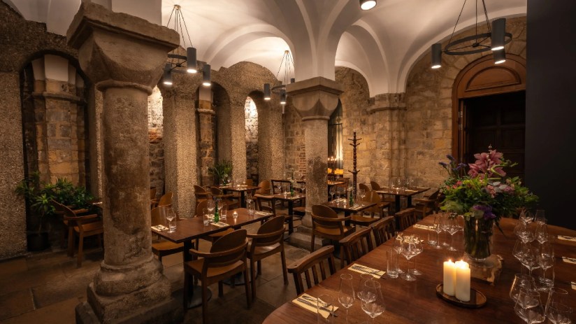 Exterior view of Humble Grape Bow Lane showcasing its inviting entrance and rustic charm on a bustling London street.