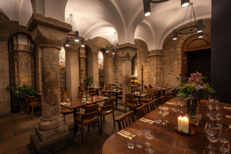 Exterior view of Humble Grape Bow Lane showcasing its inviting entrance and rustic charm on a bustling London street.
