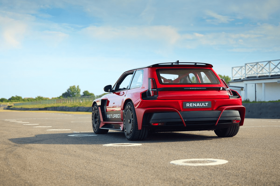 Red Renault 5 Turbo 3E electric concept car from rear on a racetrack under a blue sky