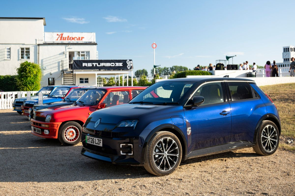 Line of Renault 5 cars, from classic red turbos to modern blue electric model, at an Autocar event.