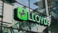 Lloyds Bank logo and sign on the exterior glass facade of a modern building in Manchester