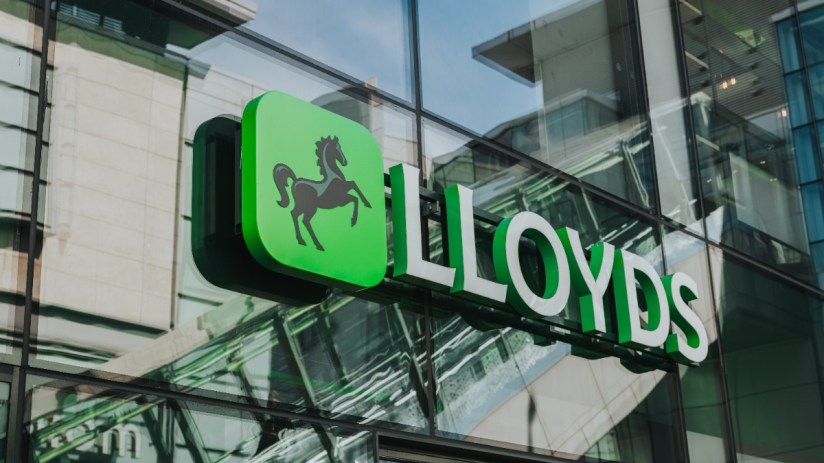 Lloyds Bank logo and sign on the exterior glass facade of a modern building in Manchester