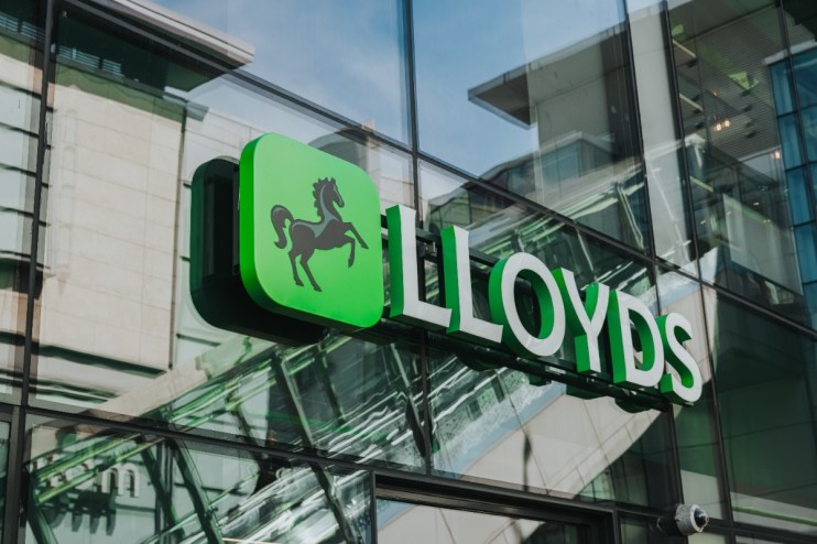 Lloyds Bank logo and sign on the exterior glass facade of a modern building in Manchester
