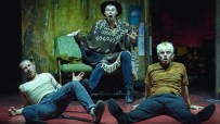 Three actors in distressed clothing on a stage, portraying characters from Trainspotting The Musical.
