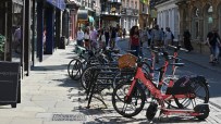 Voi electric scooters lined up on a city street, highlighting urban mobility solutions and eco-friendly transportation opt...