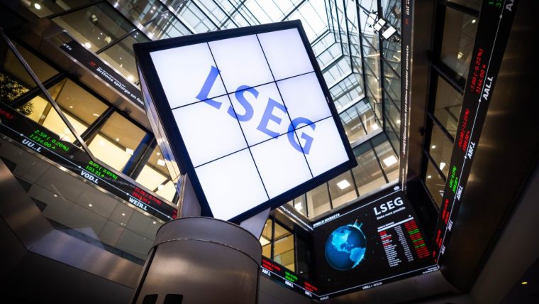 LSEG signage and digital stock market ticker displays inside a modern financial building.