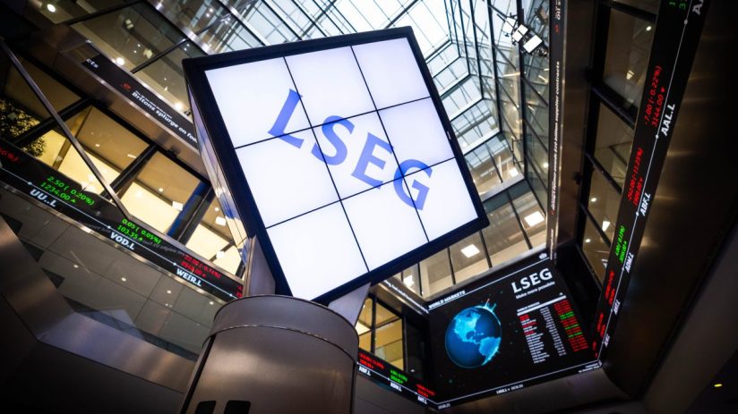 LSEG signage and digital stock market ticker displays inside a modern financial building.