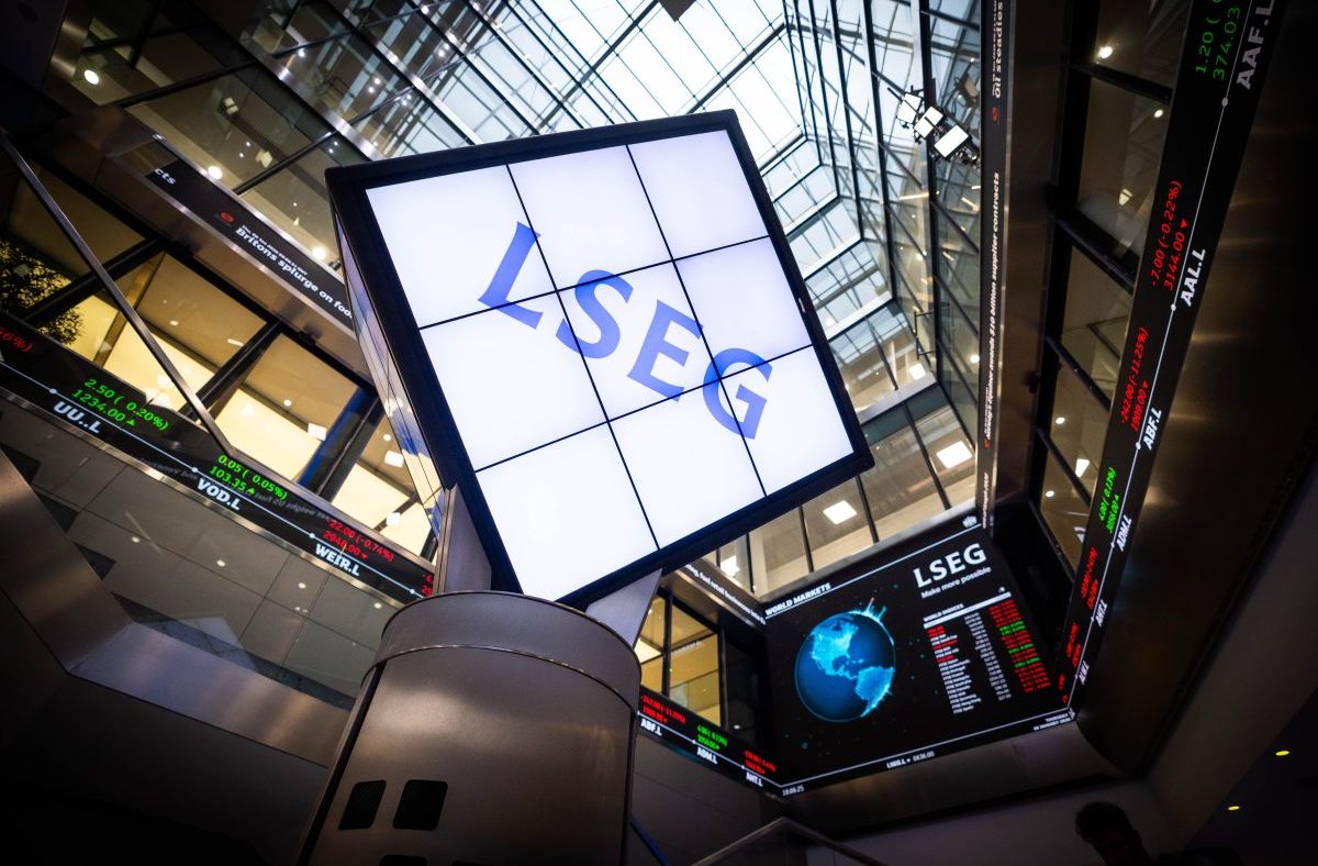 LSEG signage and digital stock market ticker displays inside a modern financial building.