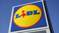 Lidl supermarket sign with blue, yellow, and red logo against a clear blue sky