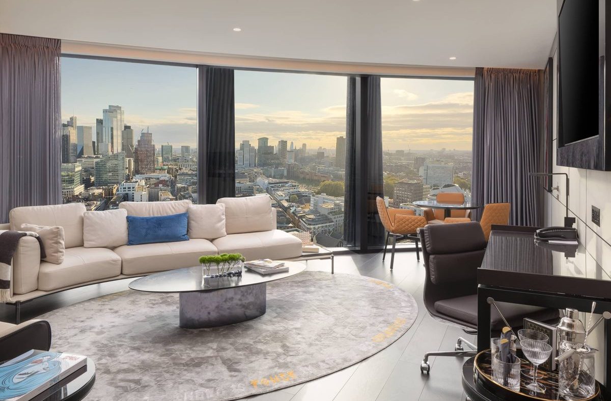 Luxurious one-bedroom suite living room at Artotel London Hoxton with city skyline views.