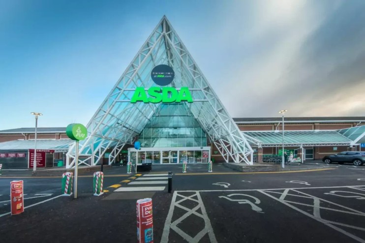 External view of a modern Asda supermarket entrance with a prominent green logo and glass pyramid-like structure.