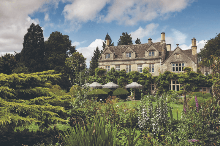 Elegant UK country house with lush gardens, perfect for a summer staycation or holiday retreat.