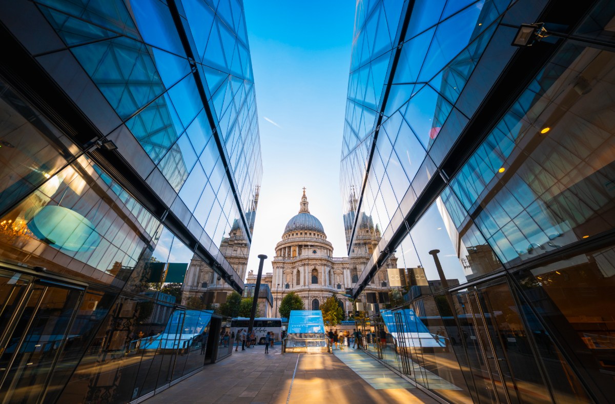 St Pauls Cathedral in London, framed by modern glass buildings under a clear sky, near Cavendishs base