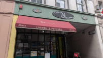 Exterior of Cheese & Peppers cafe at 11 Talbot Court, featuring a red awning and storefront.