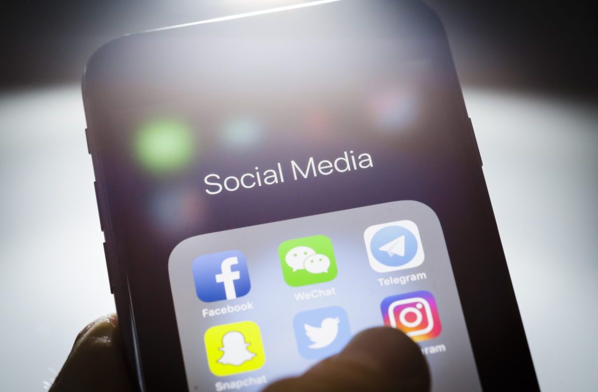 Smartphone screen displaying Social Media folder with Facebook, WeChat, Telegram, Twitter, Instagram, and Snapchat app icons.
