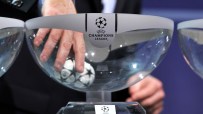 Hand drawing a UEFA Champions League football from a clear bowl during a draw ceremony