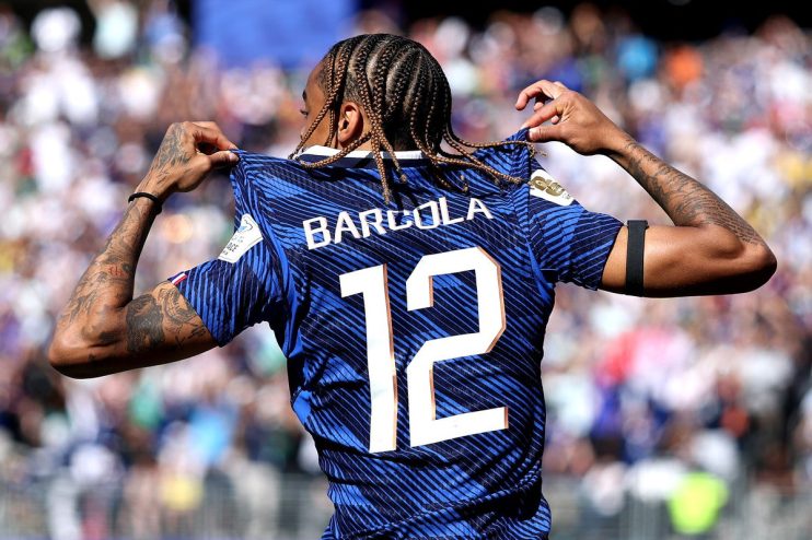 Bradley Barcola in a blue football jersey with BARCOLA 12 on the back, celebrating on the field.