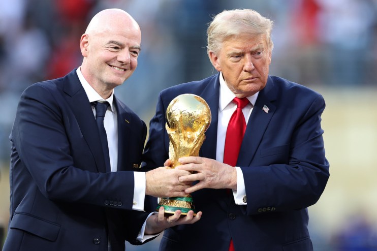 Gianni Infantino and Donald Trump holding the FIFA World Cup trophy