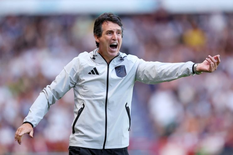 Unai Emery, Aston Villa manager, shouts with intensity during a football match, gesturing with his right arm.