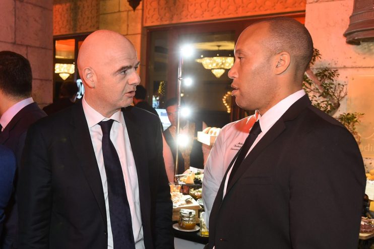 Gianni Infantino speaking with a man in a chefs jacket at a formal event