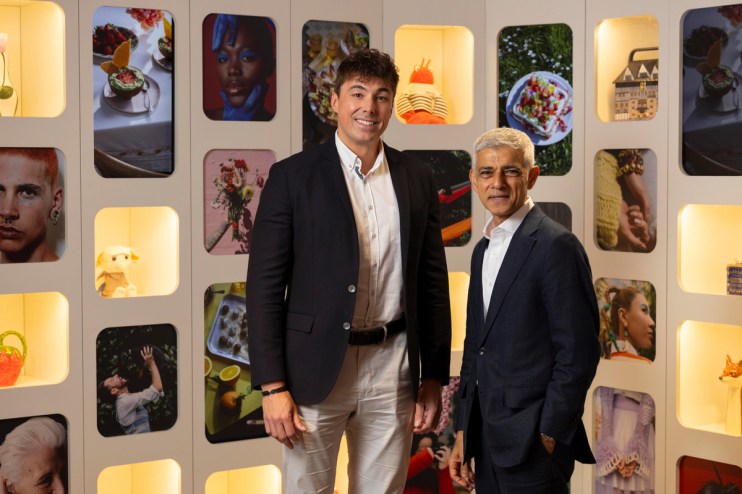 Gregory Owens and Sadiq Khan, London Mayor, stand smiling in a gallery with various framed images.