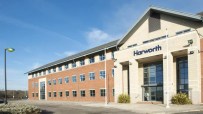 Harworth Group building exterior with a brick facade and prominent entrance under a blue sky
