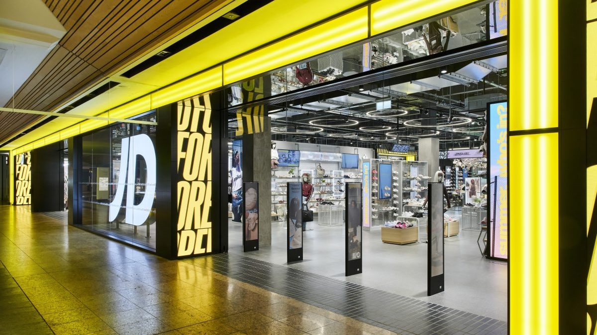 Brightly lit JD Sports store entrance at Meadowhall, showcasing footwear and apparel displays