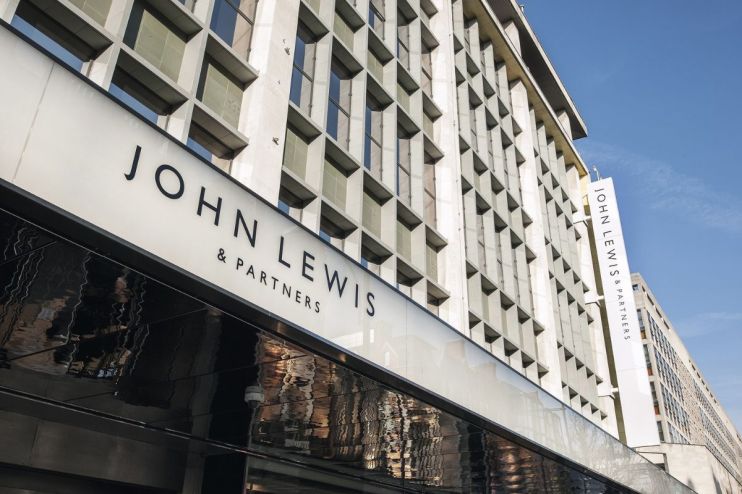 John Lewis & Partners department store building exterior with logo signage against a blue sky
