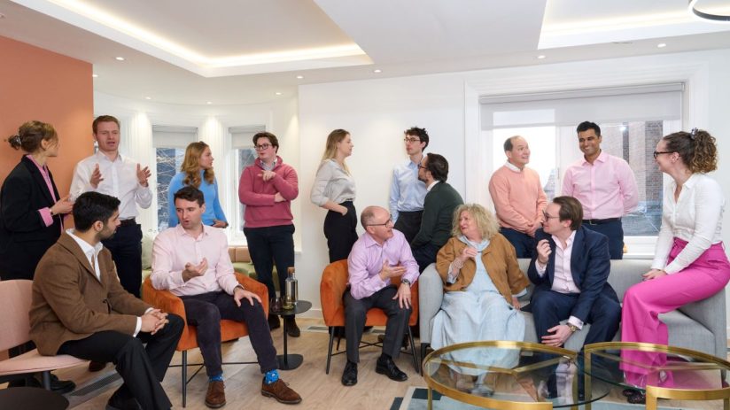 LAVA team collaborating and conversing in a bright, modern office space