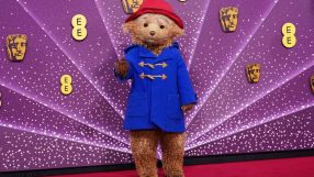 Paddington Bear in a blue duffle coat and red hat on a purple background with BAFTA and EE logos