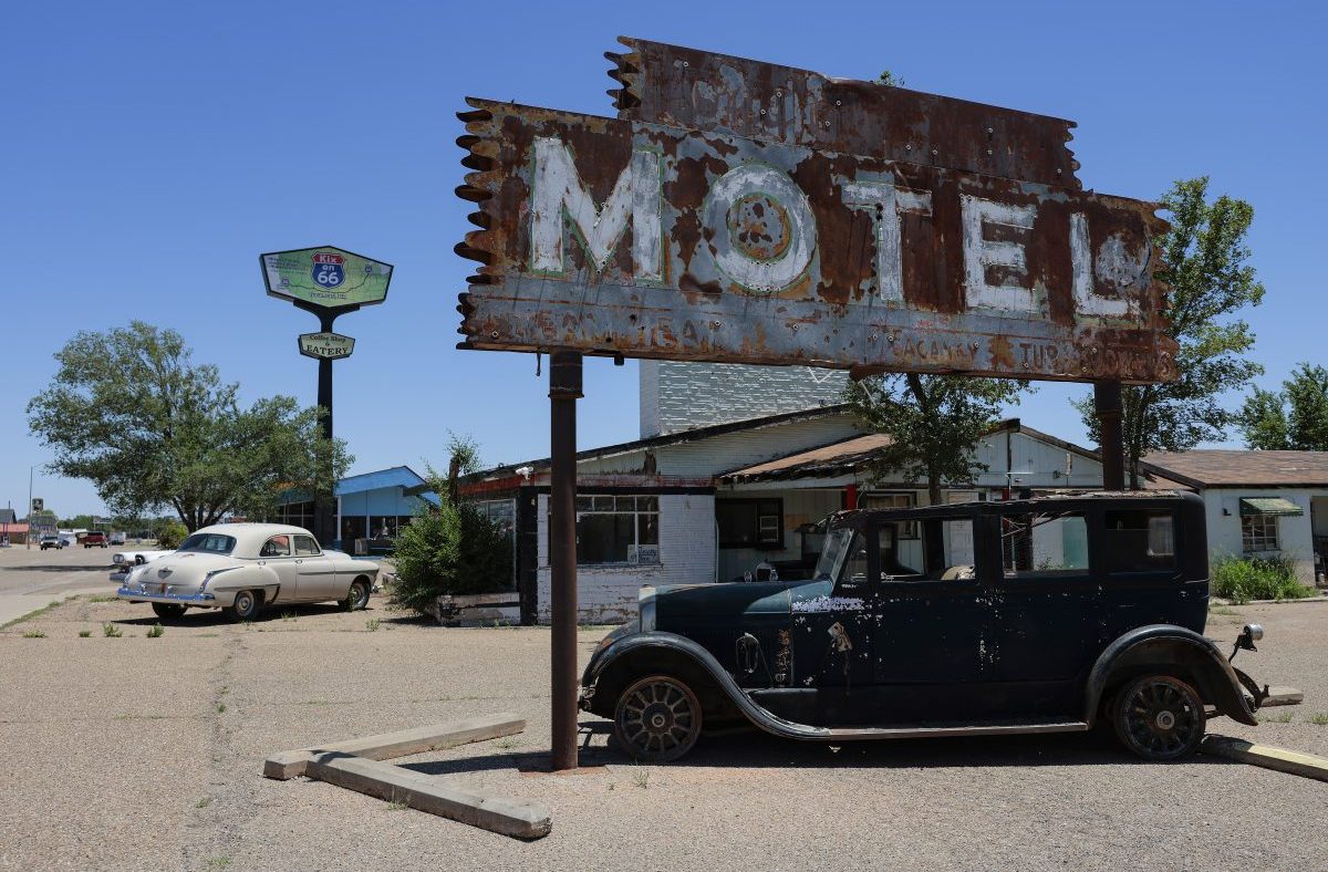 Rusty MOTEL sign, classic cars, and Route 66 Kix on 66 sign in Tucumcari, NM for a US road trip