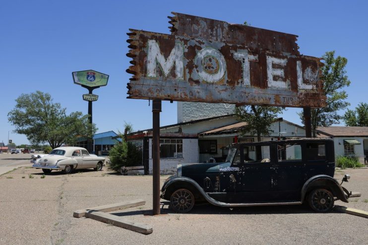 Rusty MOTEL sign, classic cars, and Route 66 Kix on 66 sign in Tucumcari, NM for a US road trip