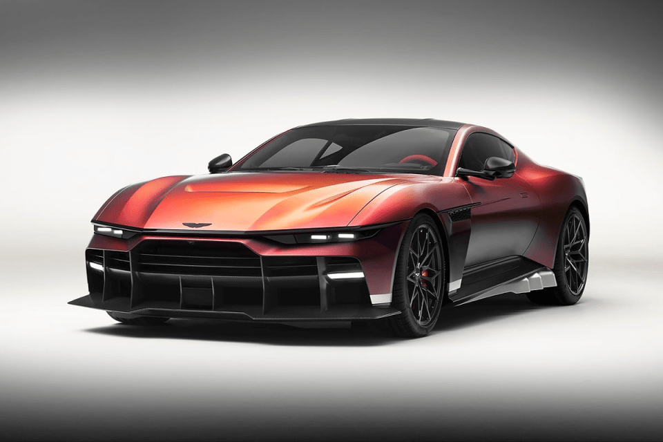 Red and purple metallic sports car with sleek design, black wheels, and aggressive front splitter on a white background