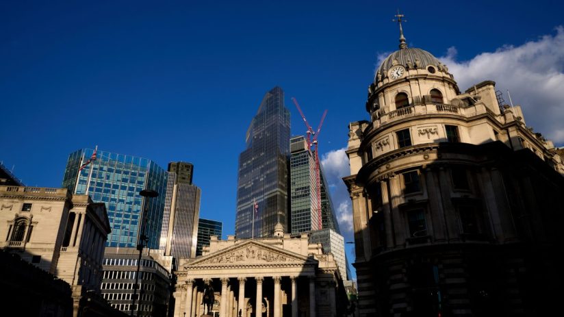 Canada skyline with historic buildings, modern skyscrapers, and construction cranes under blue sky.